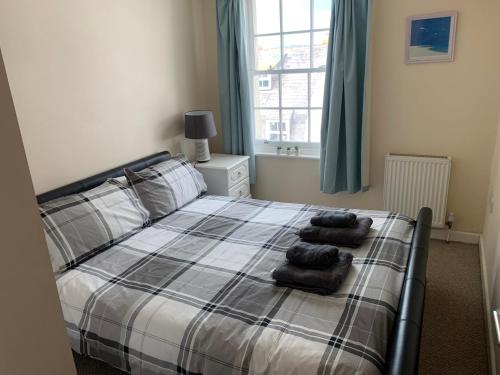sypialnia z łóżkiem z dwoma ręcznikami w obiekcie Amazing sea views ,brilliant location Apartment w mieście Weymouth