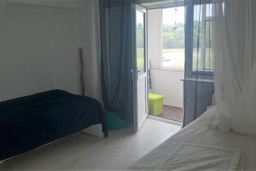 una camera con letto e porta scorrevole in vetro di Chilia 3 Apartments a Chilia Veche