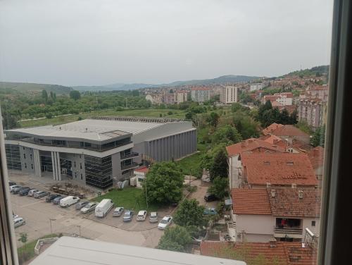 a view of a building and a parking lot with cars at Elena's flat in Kumanovo