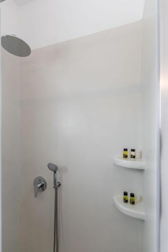 a bathroom with a shower with two shelves at Naxian Air in Agios Georgios
