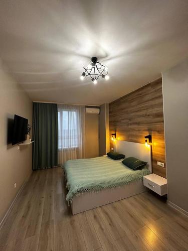 1 dormitorio con 1 cama y ventilador de techo en Апартаменти в центрі ЖК Над Бугом, en Khmelʼnytsʼkyy