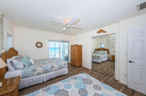 a bedroom with two beds and a ceiling fan at Vista Mar in St. Pete Beach