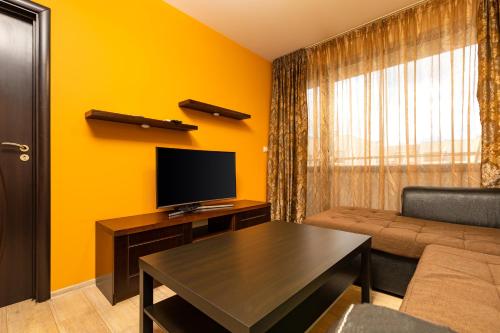 a living room with a couch and a television at South Plovdiv - 2BD Flat with Balcony by Flat Mаnager in Plovdiv