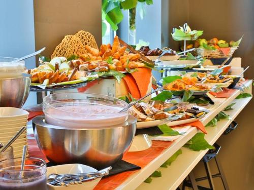 a table filled with lots of different types of food at Best Western Parco Paglia Hotel in Chieti