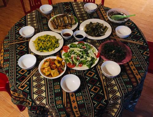 a table with plates of food on top of it at Sapa Guide Homestay & Trekking in Lao Cai