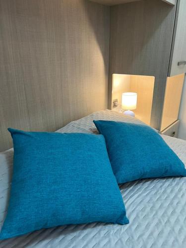 two blue pillows sitting on top of a bed at Siena Fox In in Siena