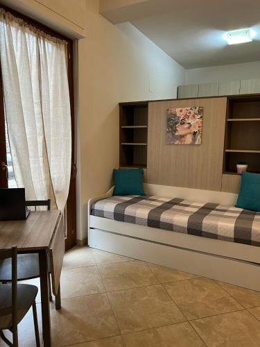 a bedroom with a bed and a table and a desk at Siena Fox In in Siena
