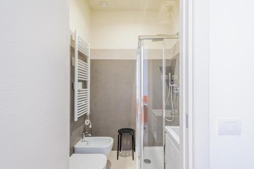 a bathroom with a toilet and a sink and a shower at Parma Room Station in Parma