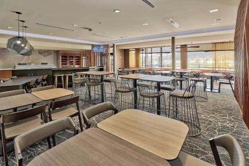 a restaurant with tables and chairs in a cafeteria at SpringHill Suites Durango in Durango