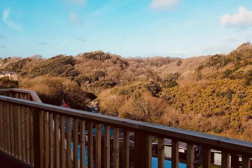 a balcony with a view of a river and trees at Summercliffe Chalet No 75 in Swansea