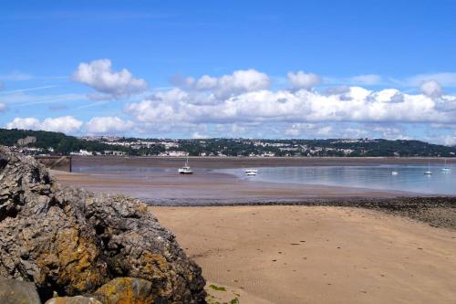 a beach with some boats in the water at Summercliffe Chalet No 75 in Swansea