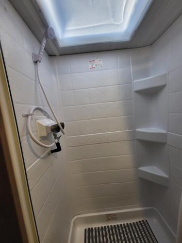 a bathroom with a shower with a toilet and a sink at Island Breeze RV in Covington