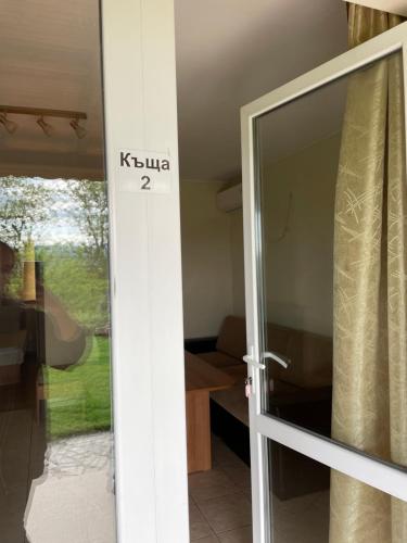a sliding glass door to a room with a table at Комплекс за гости Малки Воден in Malki Voden