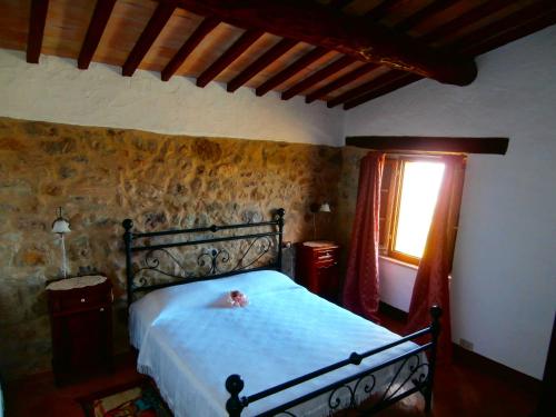 a bedroom with a bed in a room with a window at Casa Bacci in Siena