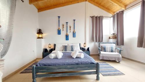 a bedroom with a large bed with blue comforter at Captain's Sea View in Vathi