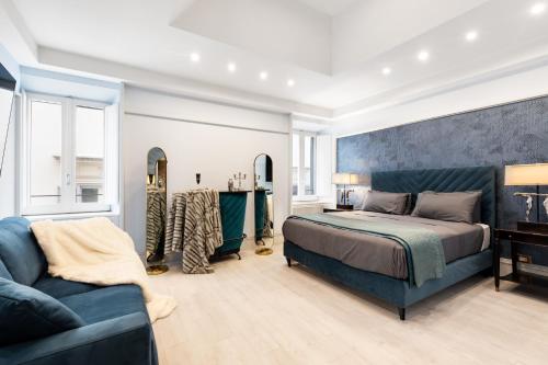 a bedroom with a bed and a couch at CIRCLE PIAZZA DI SPAGNA 60 SUITES COLLECTION in Rome