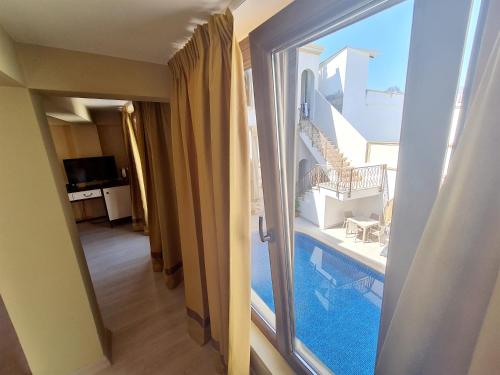 a room with a view of a staircase through a window at SOFIA BOUTIQUE HOTEL in Kérynia
