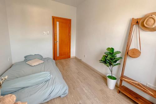 a bedroom with a bed and a plant in it at La Maison in Ấp Tân An (2)