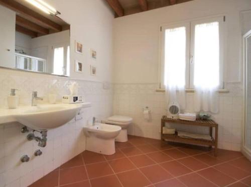a white bathroom with a sink and a toilet at Incantevole villa full optional all'Isola d'Elba in Marina di Campo