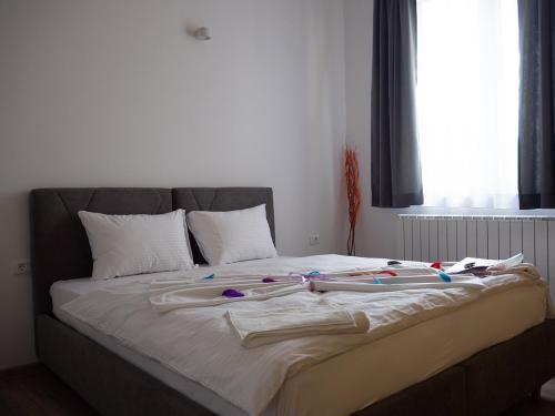 a large bed with many items on it at Motel Rezime in Zenica