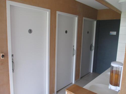 a bathroom with two white cabinets and a sink at Le Baugyte - Gite de GROUPE - 14 lits simples in Marcigny