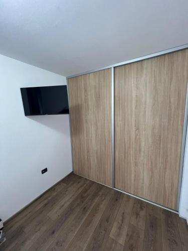 an empty room with a large wooden door at Sica GuestHouse in Borşa