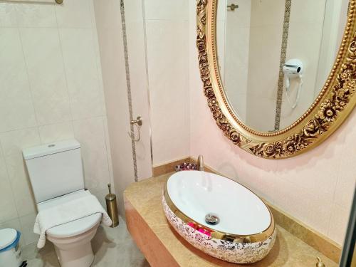 a bathroom with a sink and a mirror at SOFIA BOUTIQUE HOTEL in Kérynia