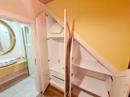 a bathroom with a staircase with white shelves at SOFIA BOUTIQUE HOTEL in Kérynia