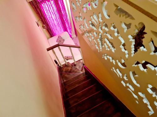 a flight of stairs with a patterned wall at SOFIA BOUTIQUE HOTEL in Kérynia