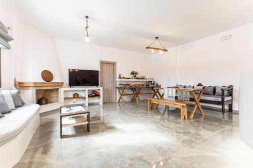 a living room with a couch and a table at Naxian Air in Agios Georgios