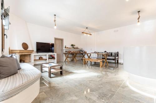 a living room with a couch and a table at Naxian Air in Agios Georgios