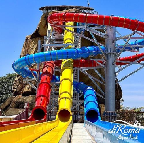 a water slide in front of a roller coaster at Spazzio Diroma Acqua Park Luxo in Caldas Novas