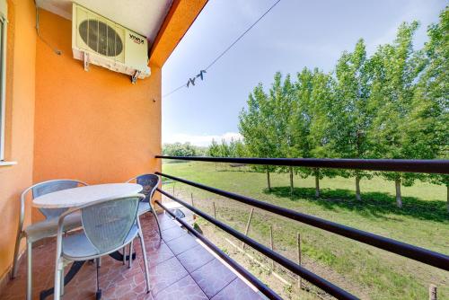 a balcony with a table and chairs and a window at Pristan Apartments in Dodoši
