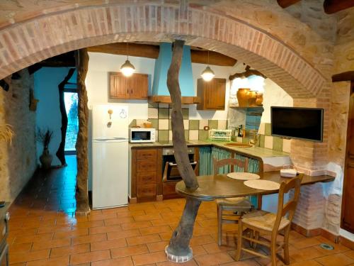 a kitchen with a table and a refrigerator at Albaga in Sant Jordi