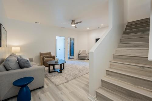 a living room with a staircase and a couch at Modern 3 Bed - 3 Bath Townhouse w/ rooftop deck in Phoenix