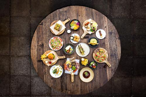 a round wooden table with plates of food on it at Broeck Oudewater in Oudewater
