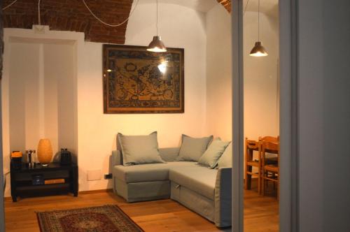 a living room with a couch and a picture on the wall at Suite The Brick in Turin