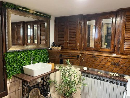 a bathroom with a sink and some wooden cabinets at Apartment Summer in Šibenik