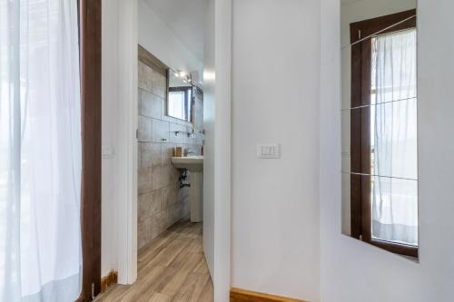 a bathroom with a sink and a mirror at A Casa Di Gaia in Riccò del Golfo di Spezia