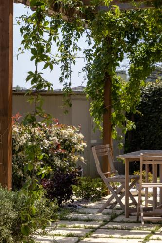 a patio with a table and a chair under a pergola at A Casa Di Gaia in Riccò del Golfo di Spezia