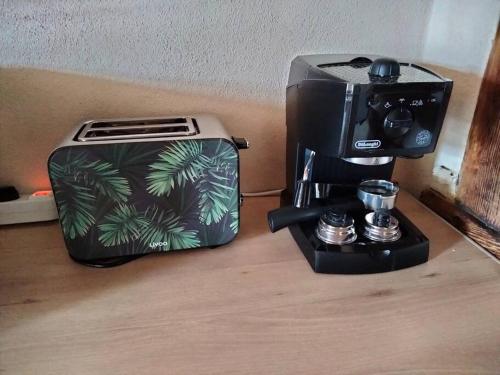 a toaster and a coffee maker sitting on a table at CHEZ GUETOU Gîte de charme en Lozère in La Tieule