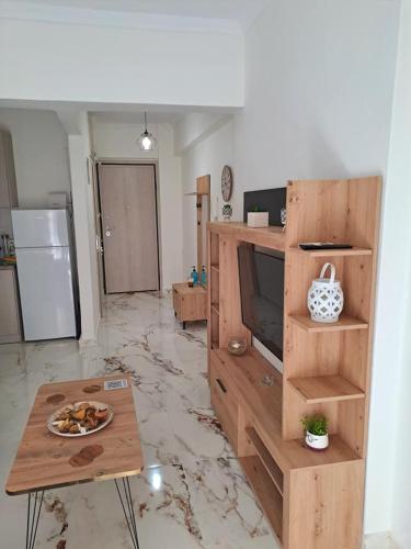 a living room with a television and a table at Cloud9 Apartment in Kavala