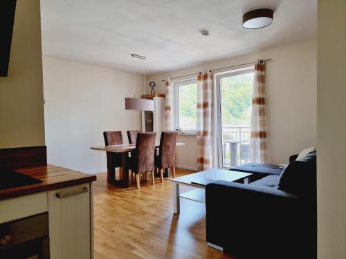 a living room with a couch and a table at Hübsches Design Apartment mit Parkplatz im Zentrum von Königstein in Königstein an der Elbe