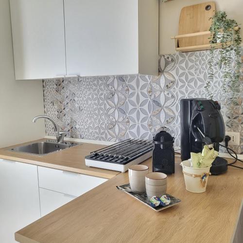a kitchen with a sink and a counter top at Sole raggiante Lia Darzillo in Afragola
