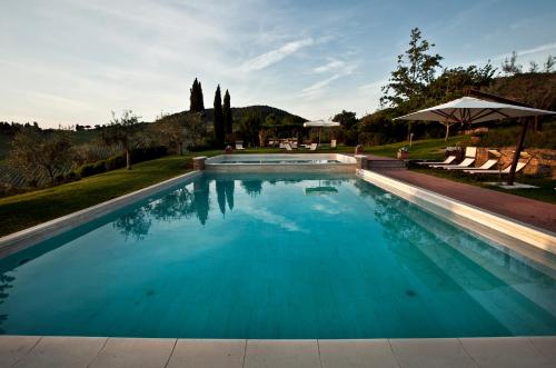 a large swimming pool with blue water at Fonte De' Medici in San Casciano in Val di Pesa