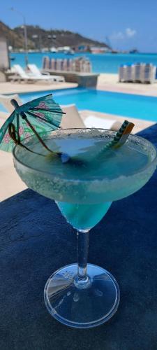 a blue drink sitting on a table next to a pool at Seaview Beach Hotel in Philipsburg
