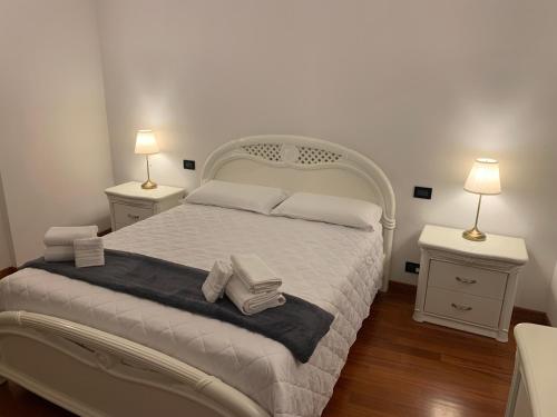 a bedroom with a white bed with two night stands at Foresteria La Corte in Castrezzato