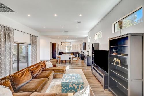 a living room with a couch and a tv at Serene Austin Stunner in Austin