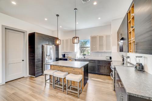 a kitchen with a counter and some chairs in it at Serene Austin Stunner in Austin