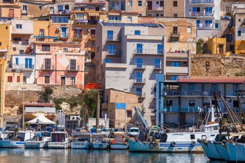 a group of boats docked in a harbor with buildings at RoccaRegina Hotel in Sciacca